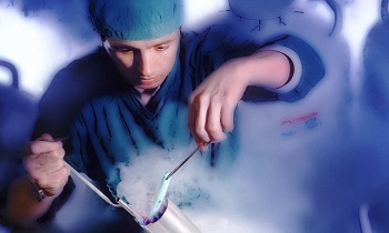 Technician working with frozen embryos